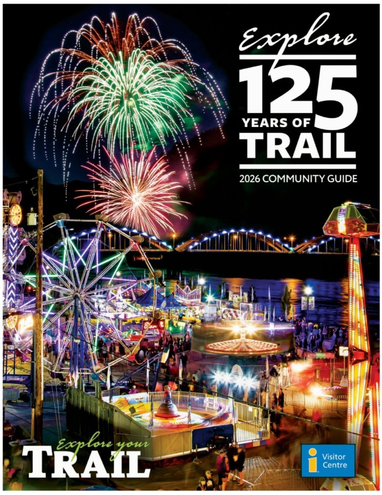 Cover of the Trail 2026 community guide with fireworks over the lit bridge at night